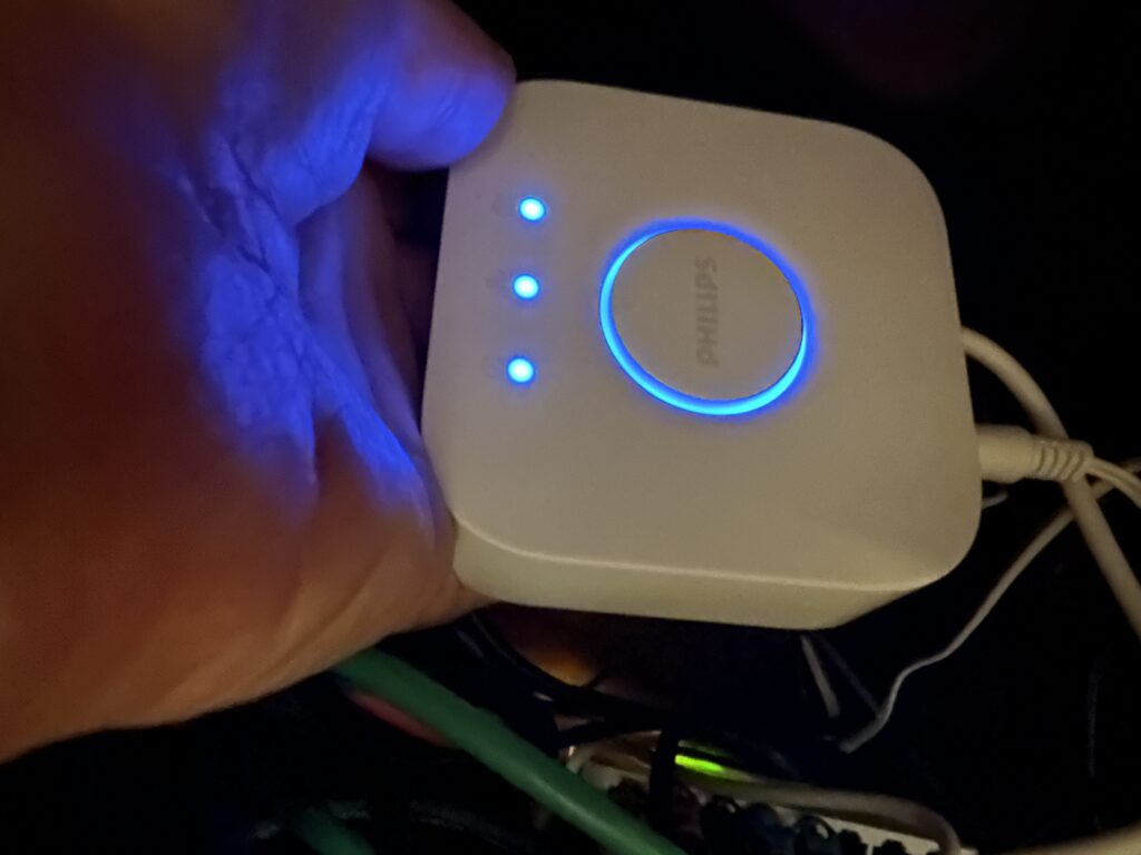 Palm-sized device with wires and blue lights. 